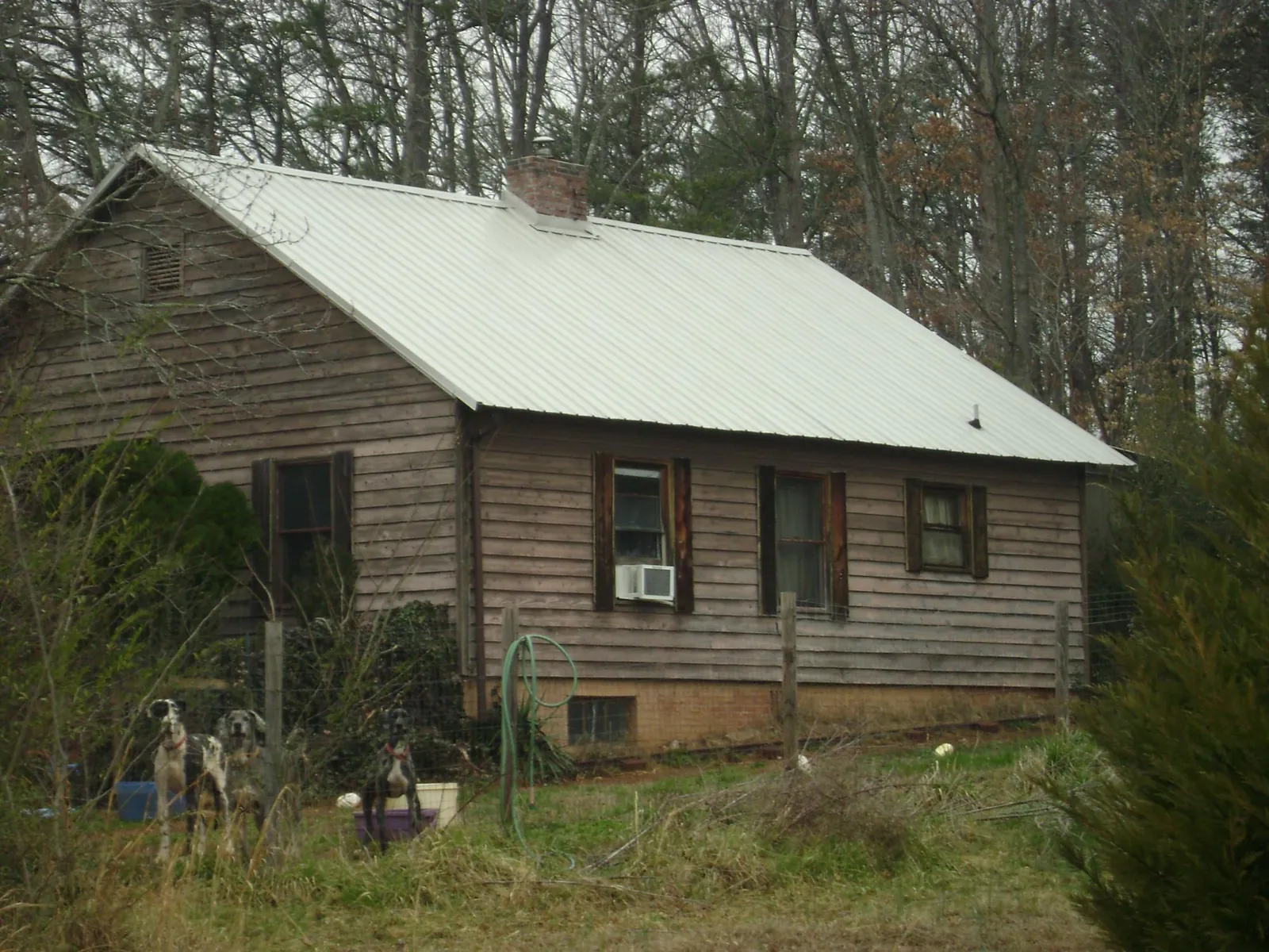 White metal roof on an old wood sided farmhouse, from a Metal Roof Installation job in Daly City